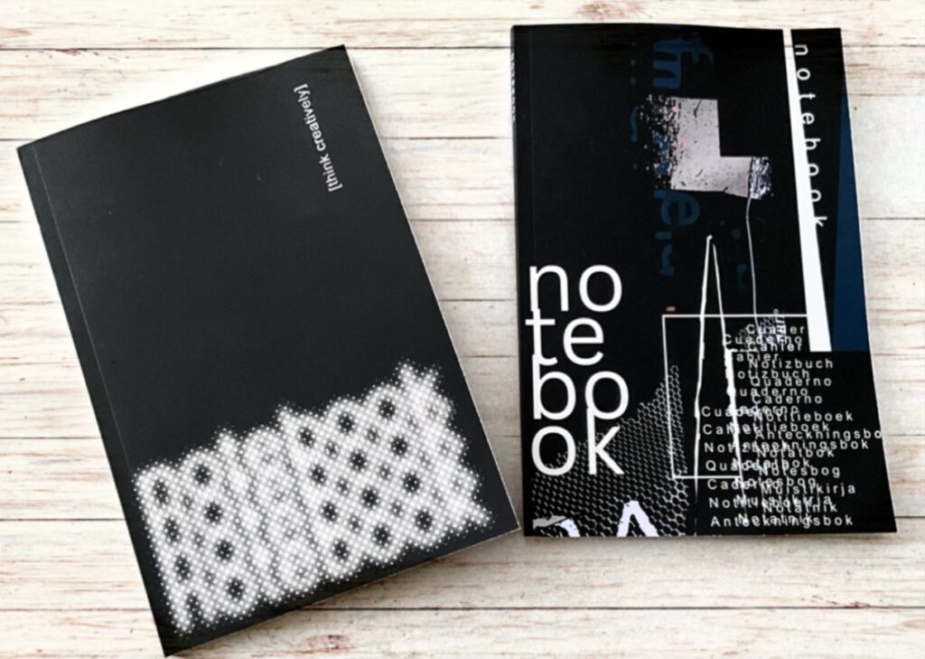 Two notebooks with strong black and white typographical design covers