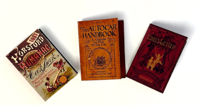 Three vintage-style miniature book covers showing finished tiny books, part of a kit for creating handmade vintage junk journals and miniature books